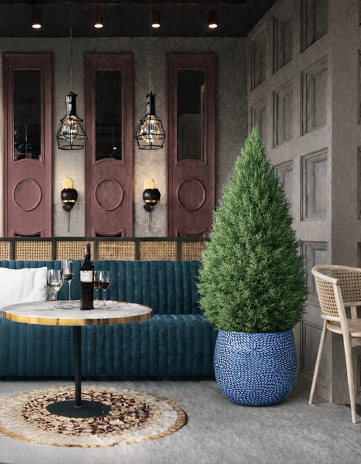 Decorative blue ceramic planter with tall evergreen plant placed beside seating in a modern restaurant interior