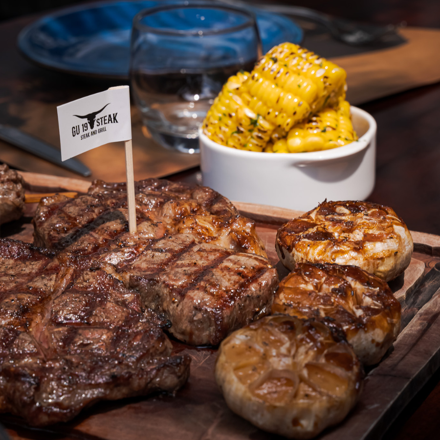 medium steak and garlic and corn cob